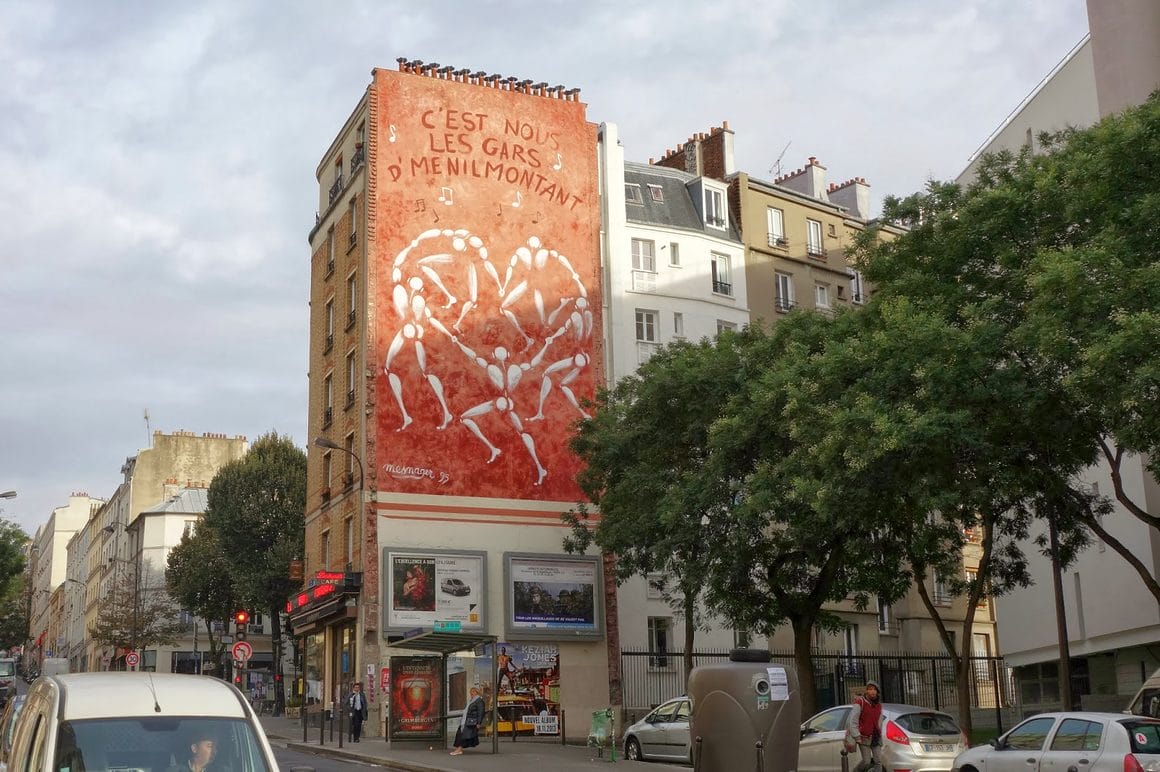 Mur recouvert d'une oeuvre de Jérôme Mesnager où on voit ses bonhommes en rond main dans la main. Inscription "c'est nous les gars d'menilmontant"